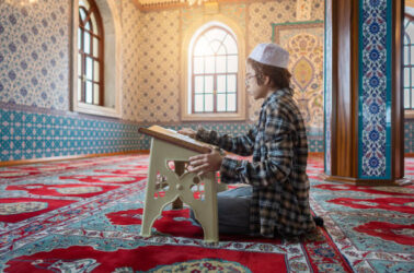 Turkish Muslim Young Boy Reading The Holy Book Koran in Mosque